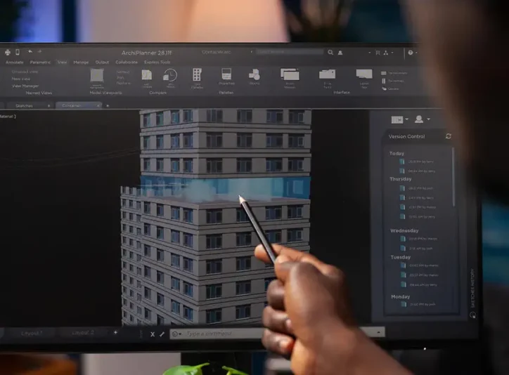 An-architect-engineer-analyzing-a-construction-model-on-a-computer-pointing-at-an-architectural (1)
